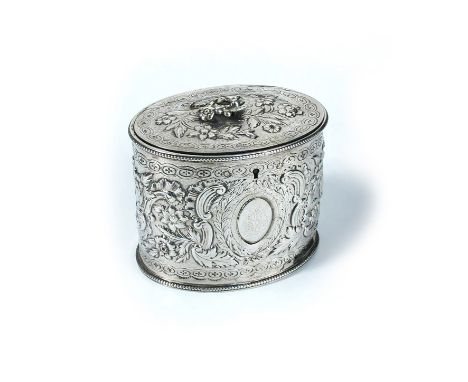 A George III silver tea caddy, maker's mark indistinct, London 1779, oval, the repousse body decorated with flowers and scrol