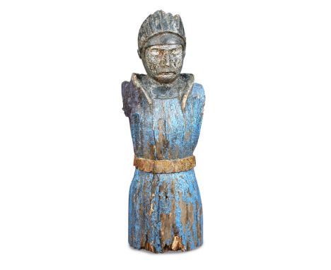 A carved wood ship’s figurehead, in the form of a Knight, wearing a helmet and long robe 148 x 53cm (58 x 21in) 
