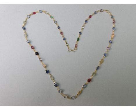 A 14ct gold and multi-coloured sapphire necklace, designed as a chain of graduated spectacle set oval cut stones, mostly sapp