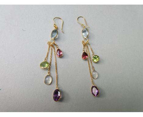 A pair of multi gem set pendant earrings, each wire hook suspending a blue topaz, which in turn suspends four fine chains of 