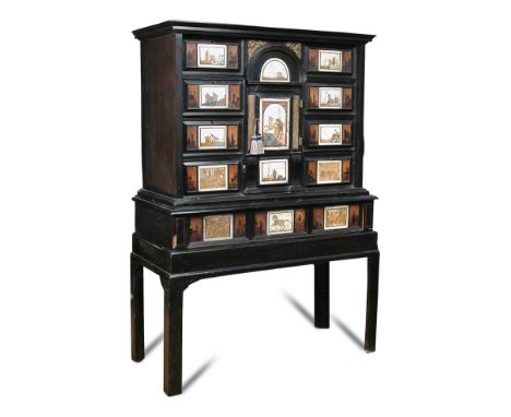 A mid 17th century Italian ebony collector’s cabinet on later stand, with architectural moulded central drawer and cupboard, 