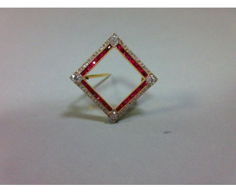 A ruby and diamond brooch, of square linear design with an old round cut diamond in a square millegrain field at each corner 