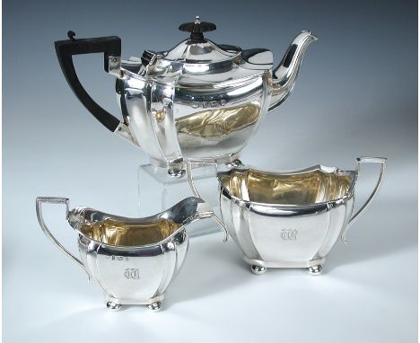 An Edwardian silver three piece tea set, by Williams (Birmingham) Ltd, Birmingham 1904, comprising:- a teapot of lobed octago