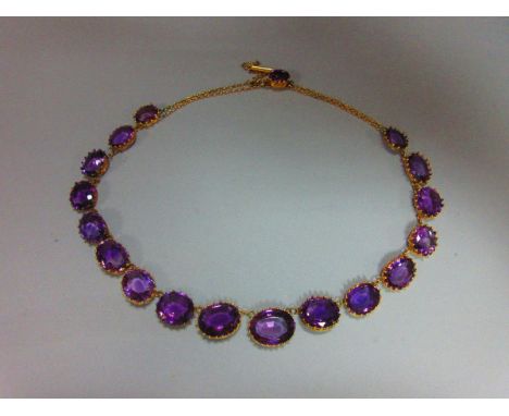 A late 19th century amethyst rivière necklace, of graduated oval cut amethysts in fancy coronet and beaded claw settings, the