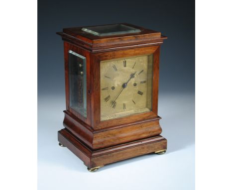 A 19th century rosewood mantel clock, the moulded rectangular case with bevelled glass top and side panels, gilt foliate engr