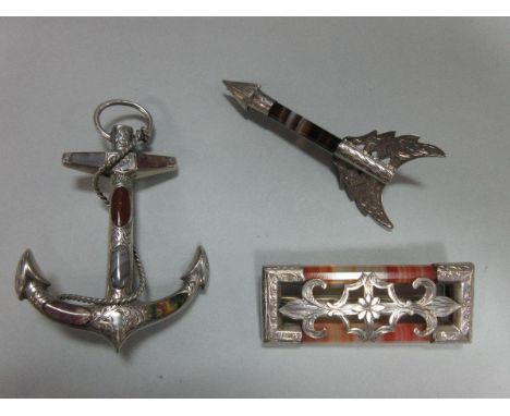 Three Victorian brooches set with banded and other agates, the first in the form of a fouled anchor with six shaped panels of