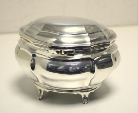 A small Edwardian silver tea caddy, by Charles Stuart Harris & Sons, London 1909, of lobed bombe shape raised on four short o