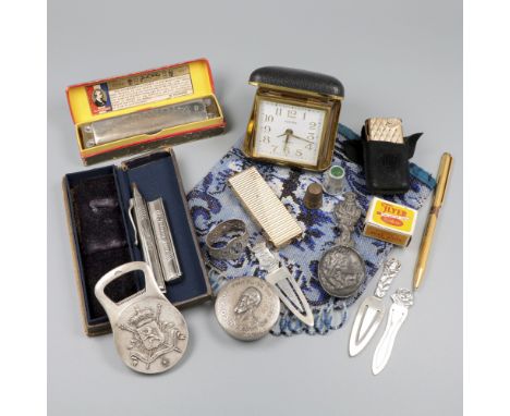 Consisting of a purse pouch with glass beads, lighters, bookmarks, Dupont pen, thimble ring, Christofle opener, Hohner harmon