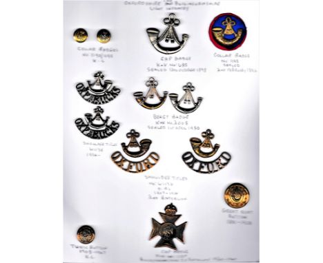 Oxfordshire &amp; Buckinghamshire Light Infantry Collection on a sheet including: Cap and Beret Badges, Shoulder Titles and B