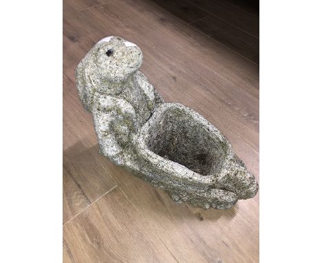 A STONE RABBIT PUSHING A WHEELBARROW GARDEN PLANTER