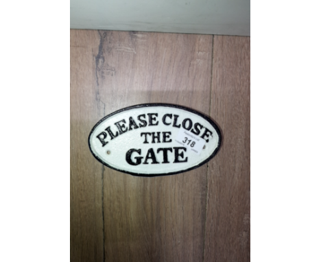 A CAST METAL SIGN PLEASE CLOSE THE GATE