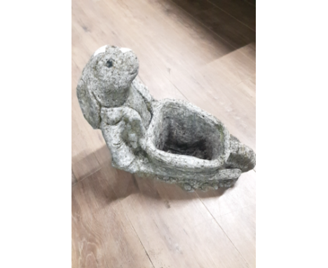 A STONE RABBIT PUSHING A WHEELBARROW GARDEN PLANTER