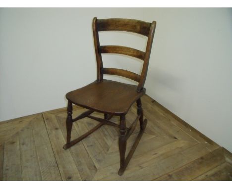 19th C country style elm rocking chair with ladder back, turned supports and H shaped under stretcher