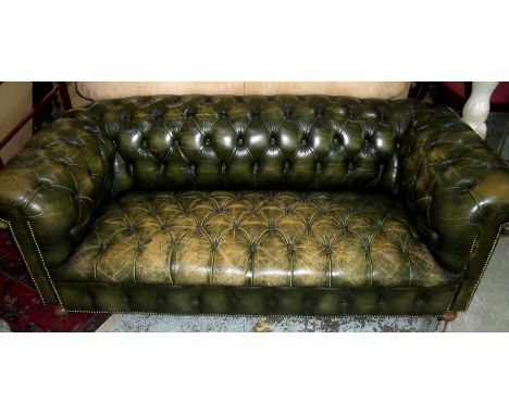 Green three seater Chesterfield style sofa on turned supports