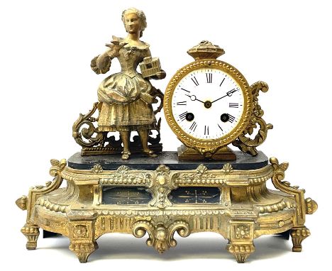 Late 19th century French gilt metal figural mantel clock, the circular enamel Roman dial beside figure of a girl holding a bi