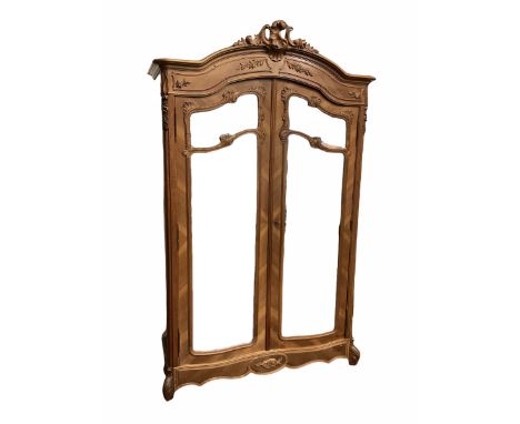 French walnut armoire wardrobe, carved feature above projecting cornice, two mirrored doors revealing shelving and hanging ra