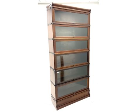 Early 20th Century mahogany Globe Wernicke style seven graduated height stacking book case, with shaped cornice and plinth ba