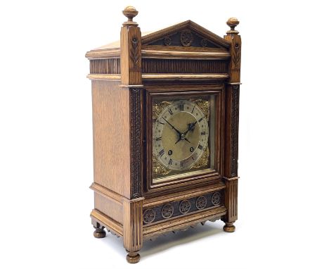 Late Victorian oak mantel clock in architectural case, sloped pediment flanked by two raised turned finials, reeded frieze an