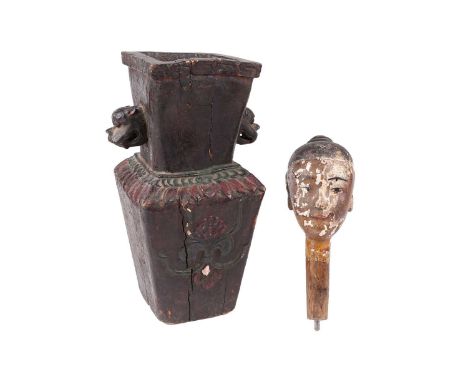 A 19th century Chinese carved wood mannequin/puppet head, with traces of paint over gesso, a metal hook inserted at the rear,