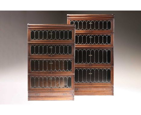 A pair of Globe Wernicke four-section modular stacking oak bookcases each bookcase with leaded glazing and a shaped frieze dr