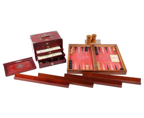 A Chinese early 20th century cased bamboo and bone Mahjong set with tile trays marked for the geographic points. Together wit