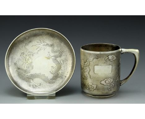 A set of Chinese sterling silver cup and saucer by Teh Ling. Decorated with engravings of dragons. Height of cup: 9 cm. Total