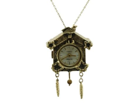 A vintage 14K gold pendant/watch by Lee Mors. Designed as a cuckoo clock. On a 14K gold necklace. Height: 4.5 cm, net weight 
