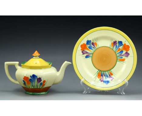 A pair of Clarice Cliff hand-painted 'Bizarre' ceramic teapot and saucer, Crocus pattern, 1930's. Plate diameter: 22.5 cm, he