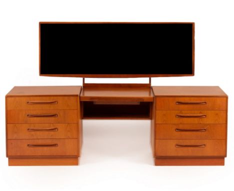 G Plan, a Fresco dressing table, the supporting chests of drawers each of four drawers flanking a central shelf, a rectangula