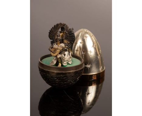 Stuart Devlin (1931-2018), a silver and silver gilt Christmas surprise egg, the lid engraved stairs, the base depicting Jerus