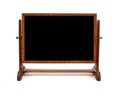 A Gordon Russell oak dressing mirror, the rectangular bevelled plate supported by octagonal pillars, the glass 36cm high x 56