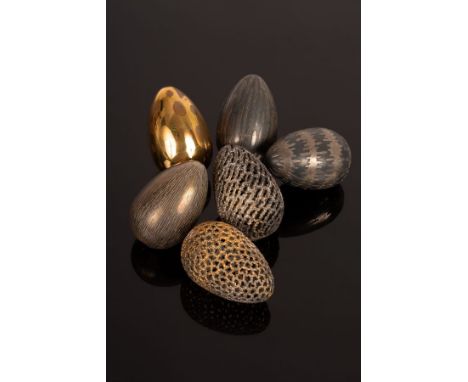 Stuart Devlin (1931-2018), a boxed set of six silver and silver-gilt eggs, each with a different textured, engraved or pierce