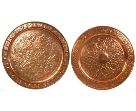 Keswick School of Industrial Arts, two large copper chargers, one embossed flowers within a scroll border, impressed mark, 57
