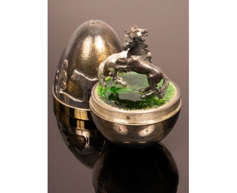 Stuart Devlin (1931-2018), a silver and silver gilt surprise egg, the lid with band of silhouetted horses and trees, the inte