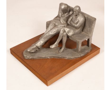 Amelia Shaw-Hastings, a modern plaster sculpture of a couple seated on a bench, initialled AH, on a rectangular wood base, 29