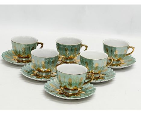A Mid 20th Century decorative porcelain coffee set. 6 cups and 6 saucers.