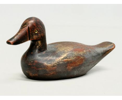 A vintage wooden duck decoy with glass eyes. 18m