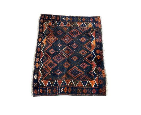 A vintage hand knotted Persian rug. 84x110cm