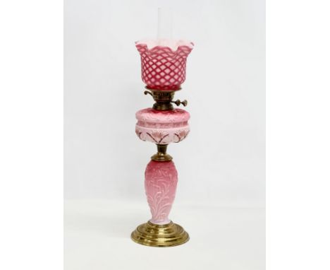A large Late 19th Century Victorian double burner, opaline glass oil lamp. With diamond shade, embossed flower bowl and colum