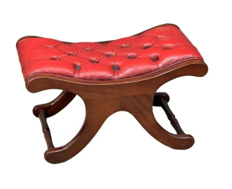 A deep button leather footstool.