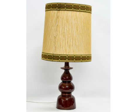 A large Mid Century glazed pottery table lamp with original shade. 82cm