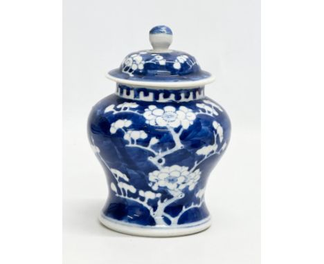 A Late 19th Century Chinese prunus pattern jar with with cover. Kangxi 4 character mark. 11x17cm.