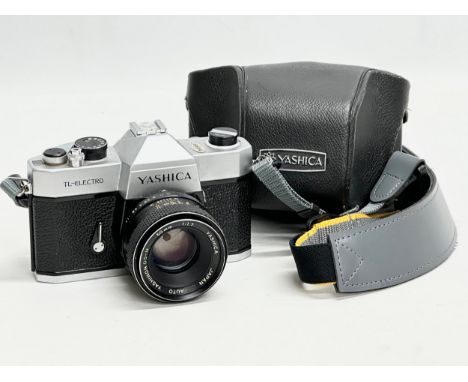 A Yashica TL-Electro camera with case.