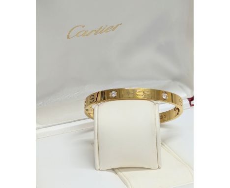 An 18ct gold and diamond Cartier bangle in case.