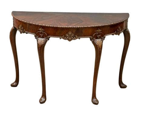 A good quality Mid 19th Century Irish mahogany console table, in the George II style. With segmented top, shell motif and gad