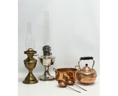 A quantity of copper and oil lamps. An Aladdin oil lamp with other, Victorian style copper kettle, pan and 2 copper utensils/