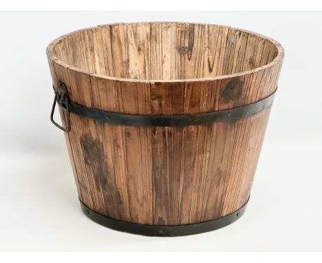 A wooden barrel form planter. 46x32cm