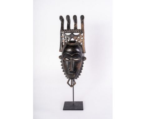 African art Portrait mask, BauleIvory Coast. . Cm 16,00 x 43,00. Black patina wooden mask with four-end headdress. This mask 