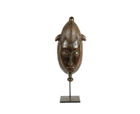 African art Portrait mblo mask, BauleIvory Coast. . Cm 20,00 x 39,00. Dark patina wooden mask. This mask belongs to the Baule