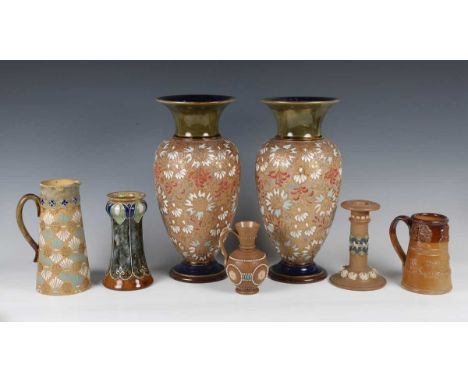 A Royal Doulton stoneware Art Nouveau vase, decorated by Florrie Jones, monogrammed, with tall stems of stylized flowers and 
